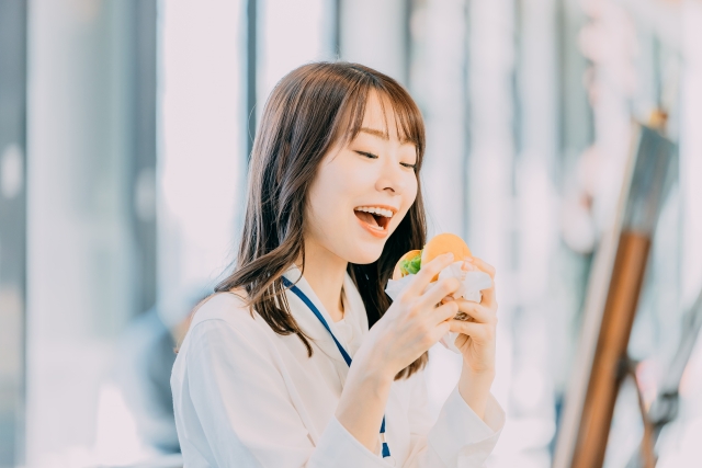 ハンバーガーを食べる女性